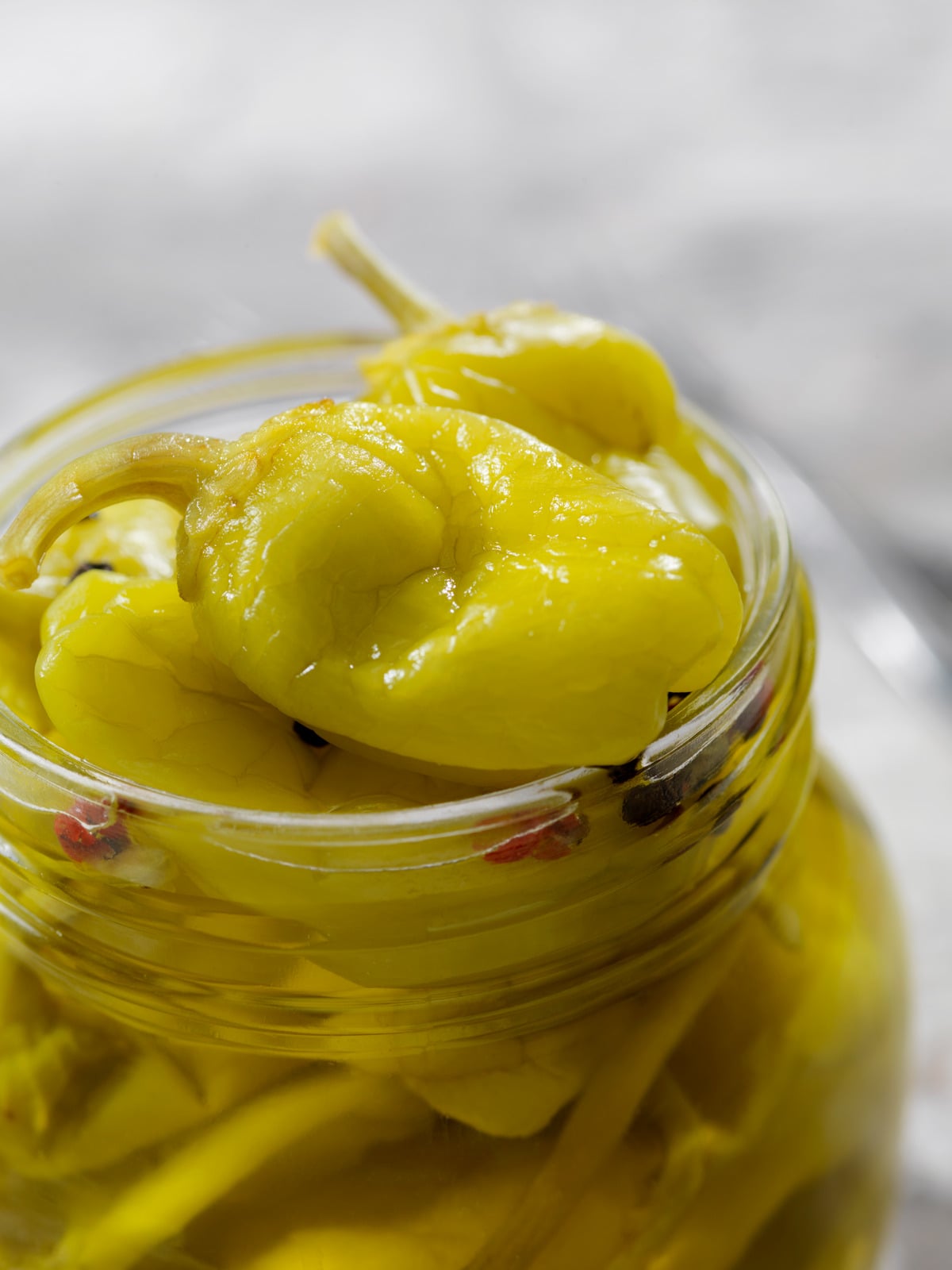 Open jar of pickled banana peppers
