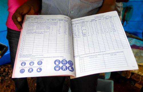 Open inspection log book on a production line desk